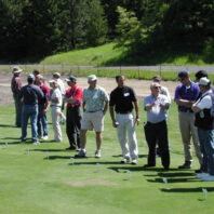 People listening to presentations at a field day.