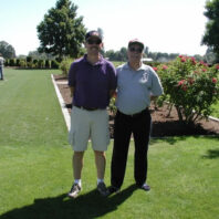 Two men side by side.