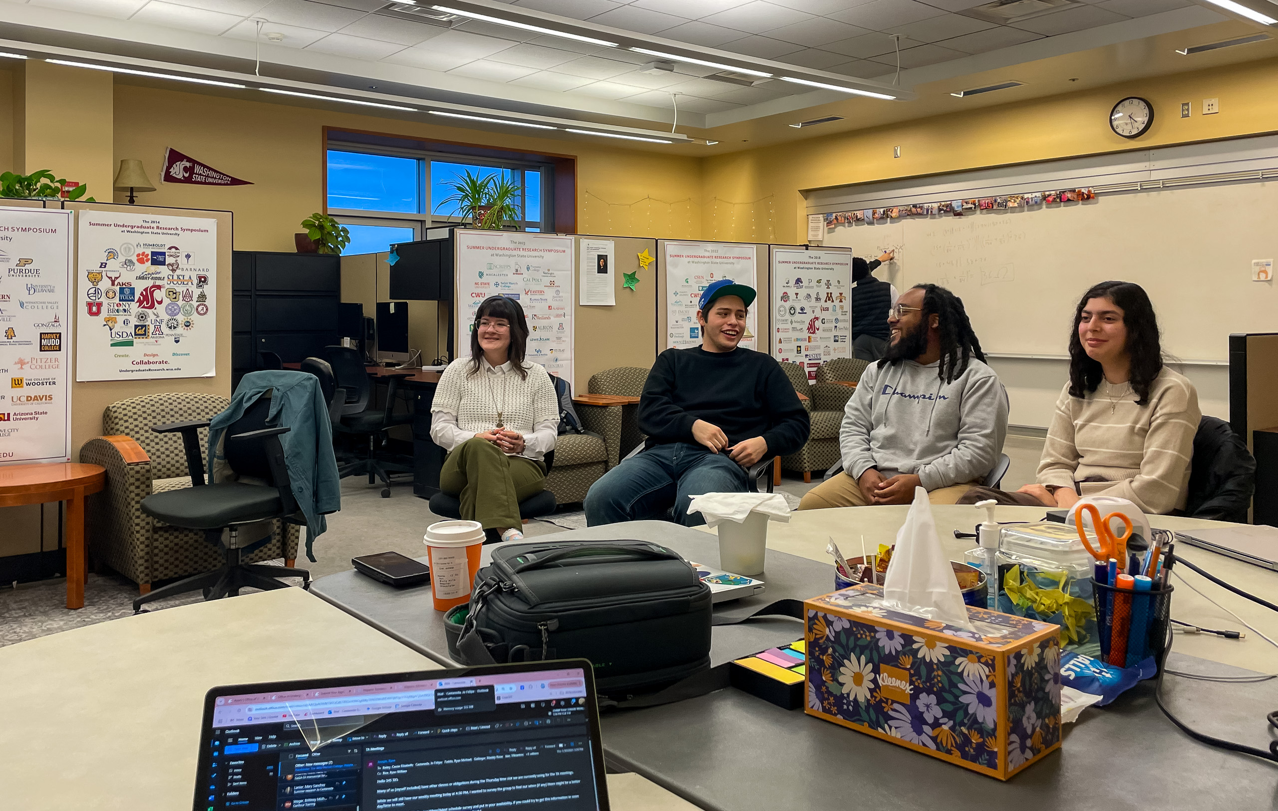 Four STEM students have a conversation with each other in the STEM Undergraduate Research Center.