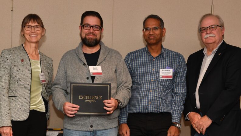 Interim Provost Bryan Slinker and ATL Director Kimberly Green presenting a certificate to Construction Management.