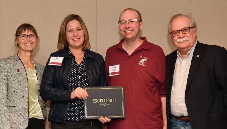 Interim Provost Bryan Slinker and ATL Director Kimberly Green presenting a certificate to Economic Sciences.