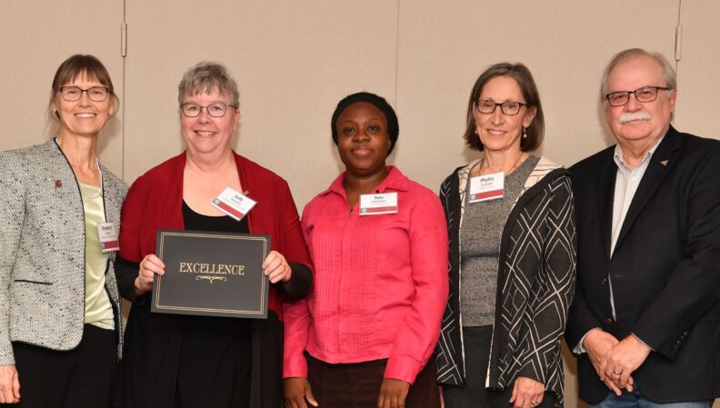 Interim Provost Bryan Slinker and ATL Director Kimberly Green presenting a certificate to Kinesiology.