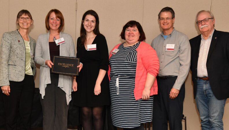 Interim Provost Bryan Slinker and ATL Director Kimberly Green presenting a certificate to Molecular Biosciences.
