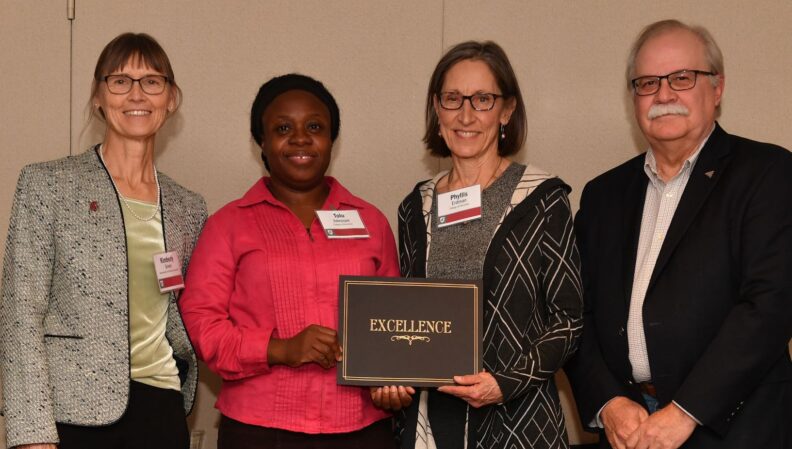 Interim Provost Bryan Slinker and ATL Director Kimberly Green presenting a certificate to Teacher Education.