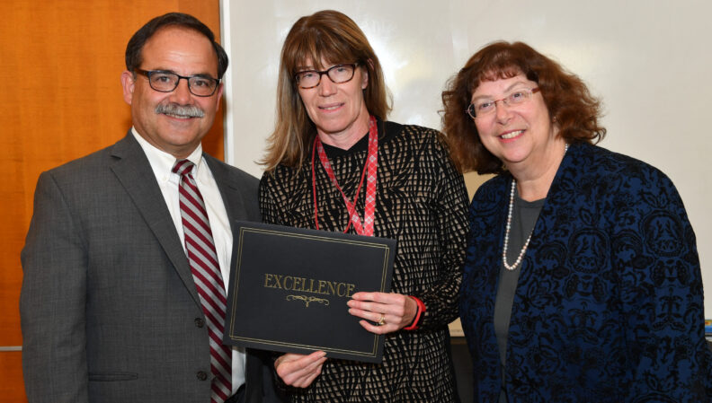 Provost Dan Bernardo and Vice Provost Erica Austin presenting a certificate to Economic Sciences.