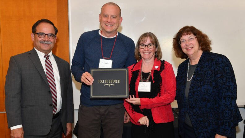 Provost Dan Bernardo and Vice Provost Erica Austin presenting a certificate to Human Development.