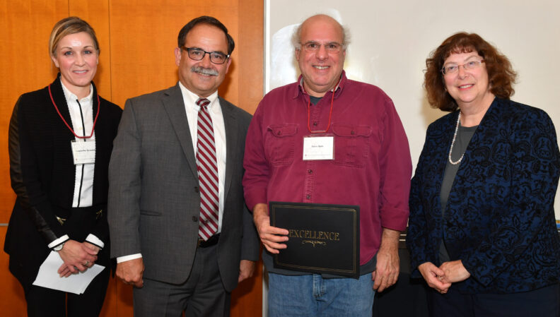 Provost Dan Bernardo and Vice Provost Erica Austin presenting a certificate to History.