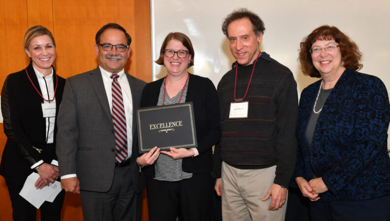 Provost Dan Bernardo and Vice Provost Erica Austin presenting a certificate to Psychology.