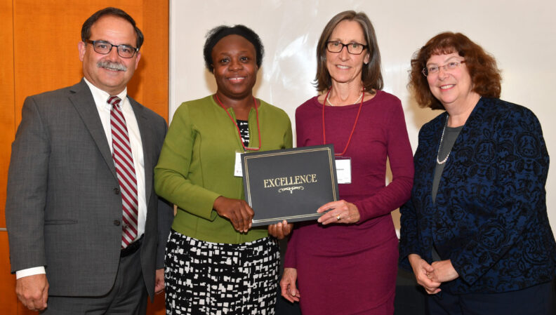 Provost Dan Bernardo and Vice Provost Erica Austin presenting a certificate to Teacher Education.