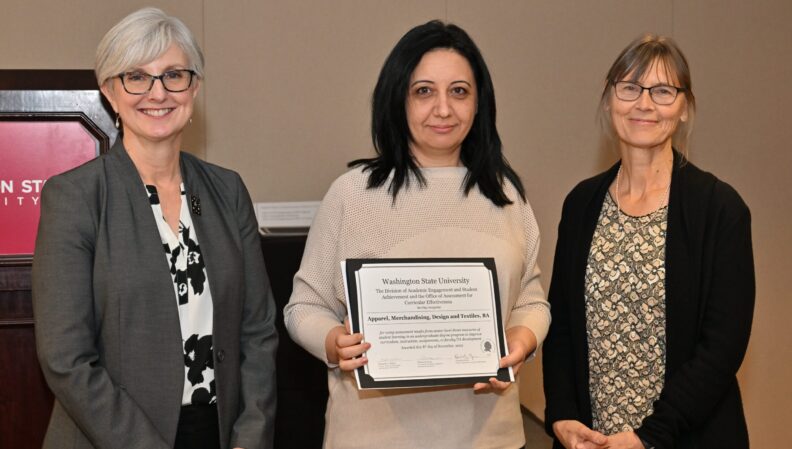Provost Elizabeth Chilton and ACE Director Kimberly Green presenting a certificate to the Apparel, Merchandising, Design, and Textiles, BA.