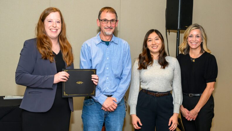 ACE Director Lindsey Brown presenting a certificate to the Anthropology, BA.