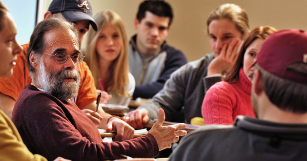 Students listen as a professor lectures.