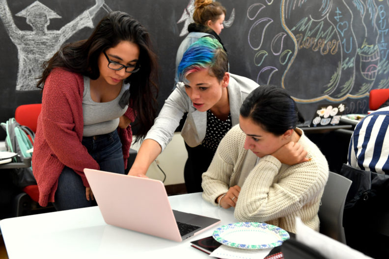 Kelly Demand having a conversation two WSU students.