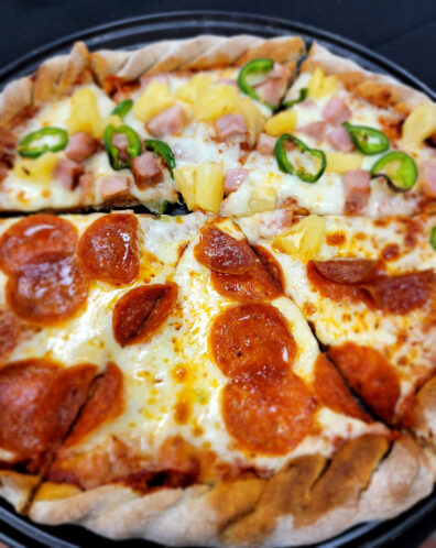 A half-pepperoni, half-pineapple, ham, and jalapeño pizza prepared by Jamie Callison, Hospitality and Business Management executive chef.