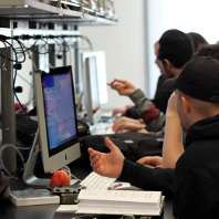 Students discussing how to solve a problem during a design project.