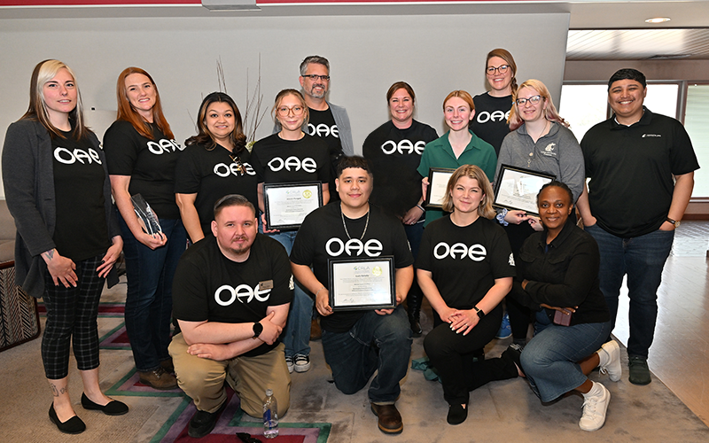 OAE staff pose together at the Lewis Alumni Center in celebration of their staff who won awards.