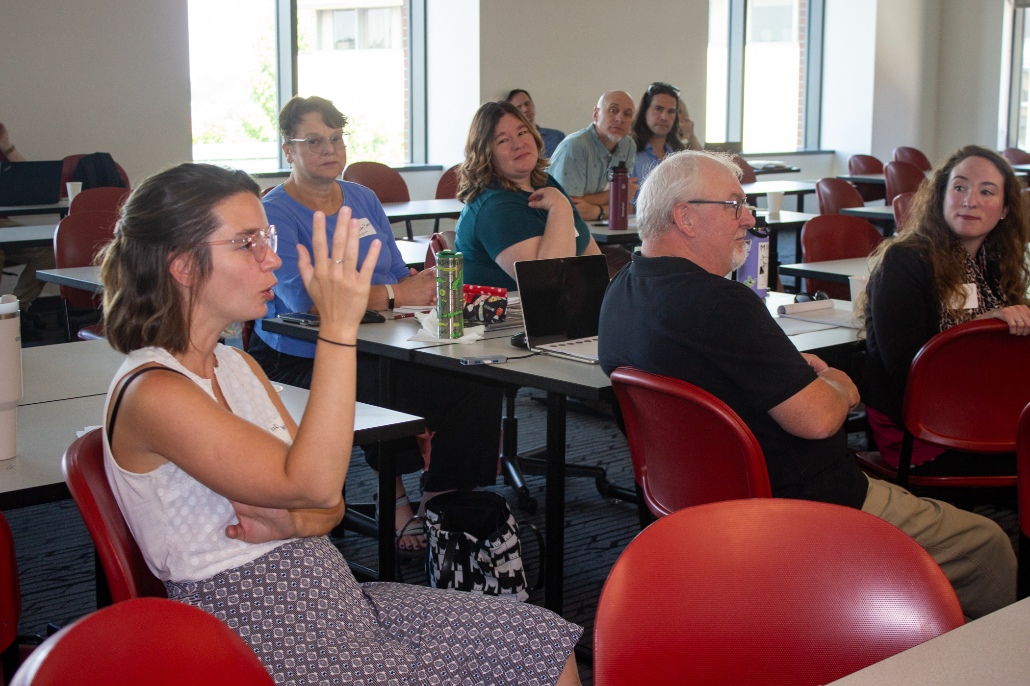A Core to Career faculty asks an audience question of the speaker at a workshop session of a fall 2023 planning session.