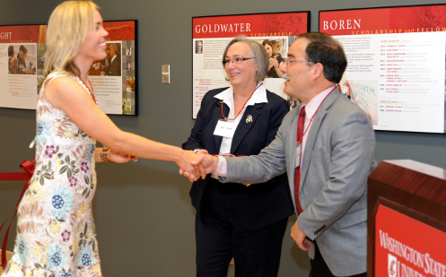 Julie Jared shakes hands with Dan Bernardo as she receives her pin.