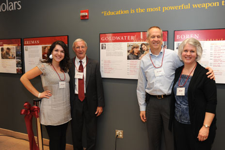 Nicole and the group pose around the wall plaque that records her accomplishment.