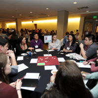April Seehafer speaking to the students at her table about Distinguished Scholarships.