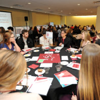 Students sitting around the table listening to Chris Oakley from Global Learning.