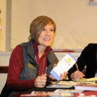 Judy Hopkins talking to students at her table about Handshake.