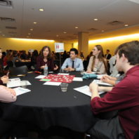 Maureen Schmitter-Edgecombe speaking with the students at her table.