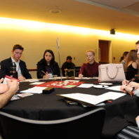 Patrick Freeze talking to the students at his table about the Fullbright Distinguished Scholarship.