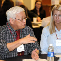 Ray Quock speaking to the students at his table.