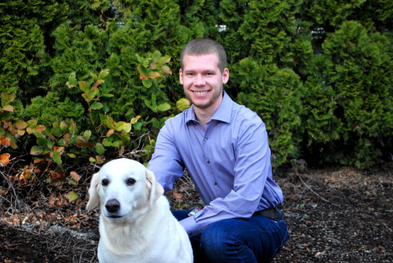Sean Thompson is shown posing with his dog Scout for a photo at his home in Woodinville, Washington.