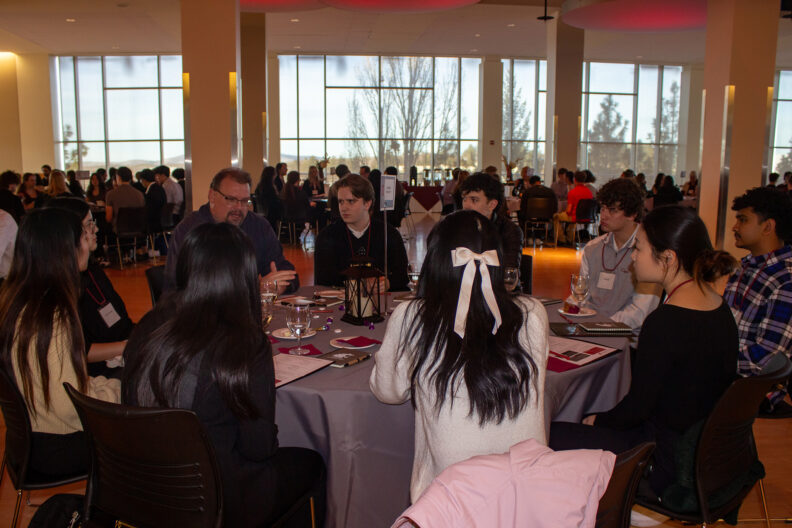 Full resolution of Jeremy Lessmann leading a table talk.
