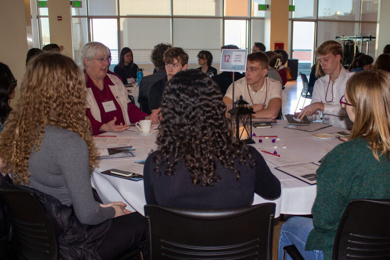 Full resolution of Lisa Gloss leading a table talk.