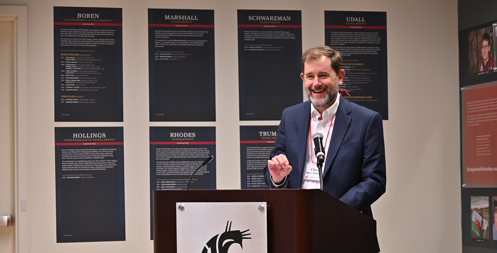 Provost Riley-Tillman speaks at a podium set up in the Distinguished Scholars gallery in the CUB.
