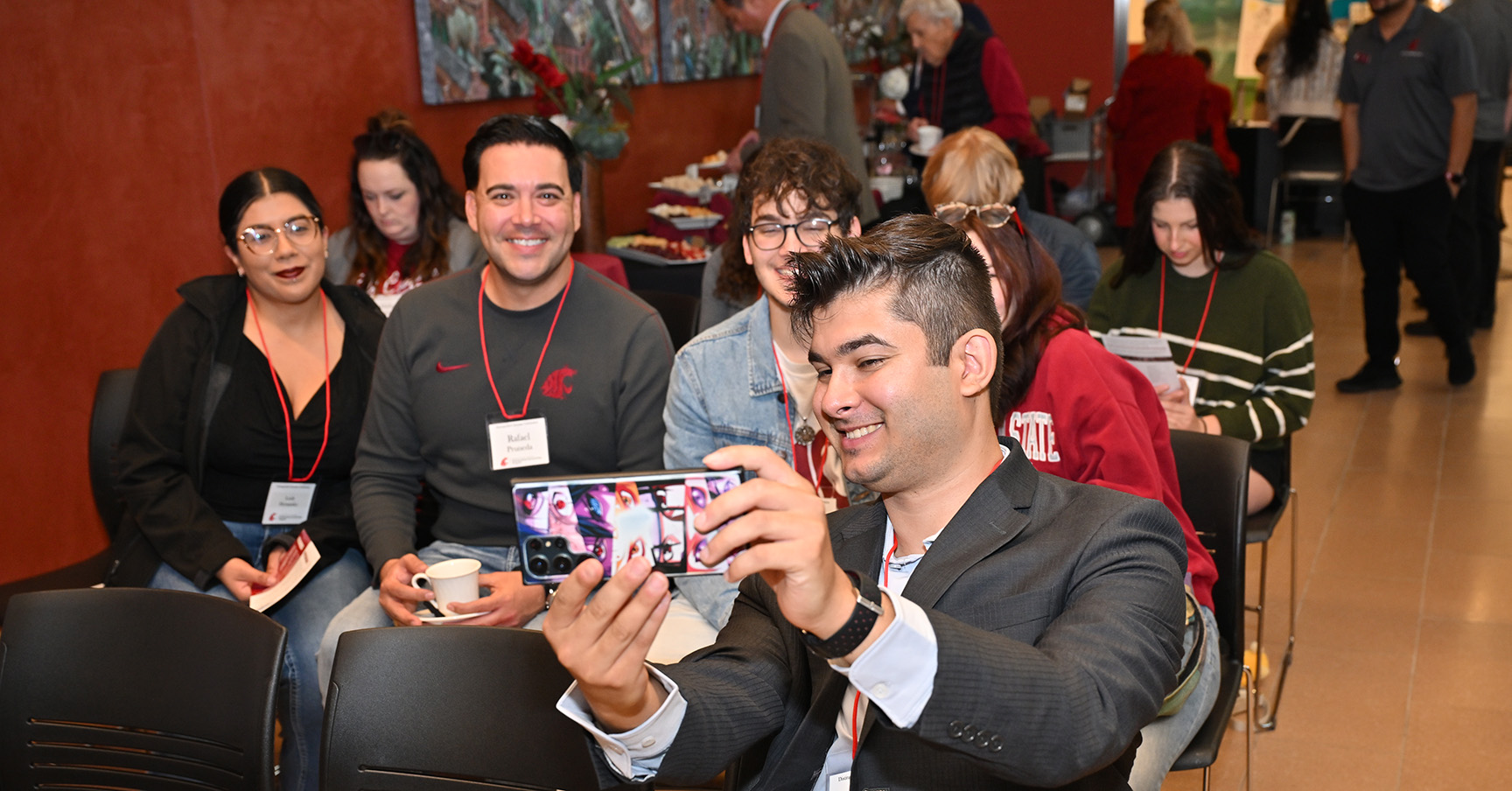 Students take a group selfie in the Distinguished Scholars Gallery at the CUB. They are seated in the audience as the annual Distinguished Scholars Celebration event gets underway.