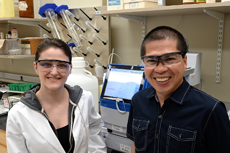 A student standing with her research mentor in the lab