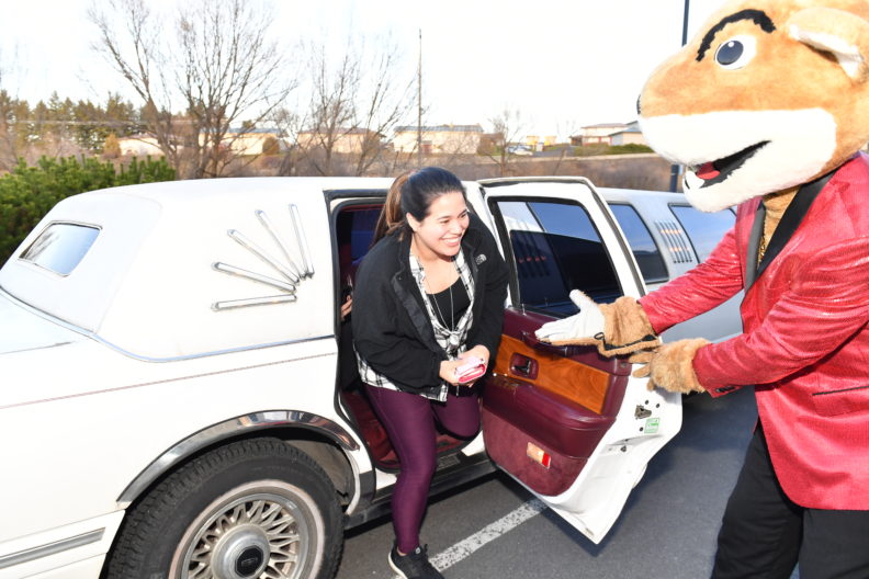 WSU's Butch helps another smiling WSU student step out of a limousine. Select to view full resolution version.