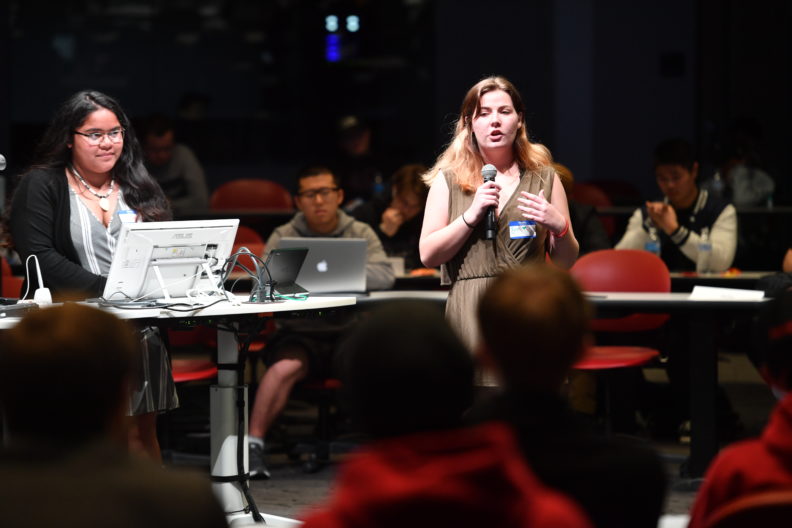Bryn Rosemore presents on the first-place winning app as team leader Amaya Kaipat looks on during the 2019 Abobe Creative Jam at Washington State University.