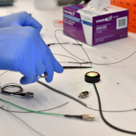 A student conducts a test on an optical sensor.