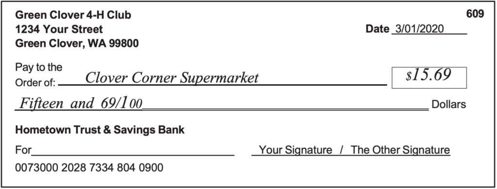Sample check filled out for $15.69 to Clover Corner Supermarket. 