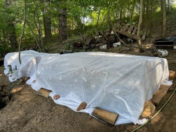 A crib stack covered with a white translucent cloth.
