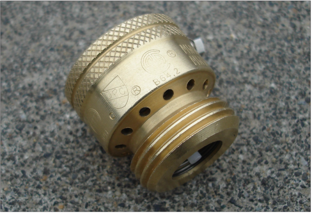 Round, gold vacuum release valve.