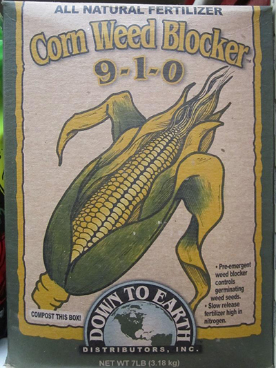 Product box labeled ‘Corn Weed Blocker 9-1-0,’ featuring an illustrated ear of corn. 