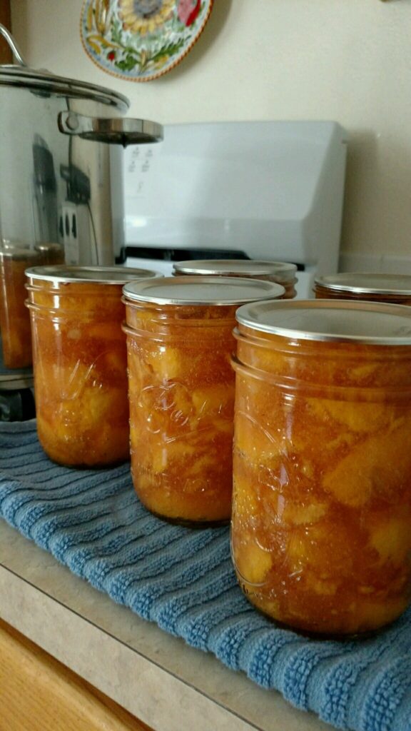 Jars of home-canned peaches.