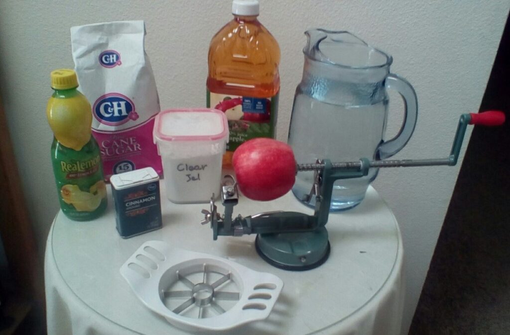 Assorted canning equipment on glass-topped, round table.