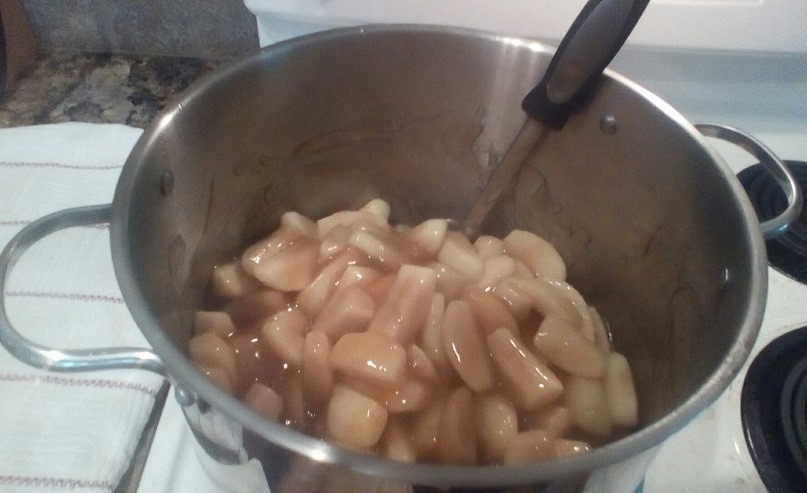 A pot of apple pie filling on stove.