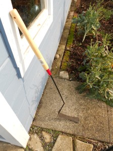 A long thin tool with an angled flat rectangle piece at the end.