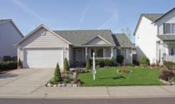 A home with a small, manicured front lawn.