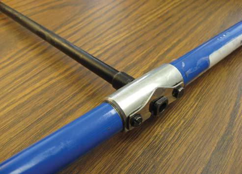 Close-up of an increment borer with the black bit inserted through the blue handle to form a T-handle.