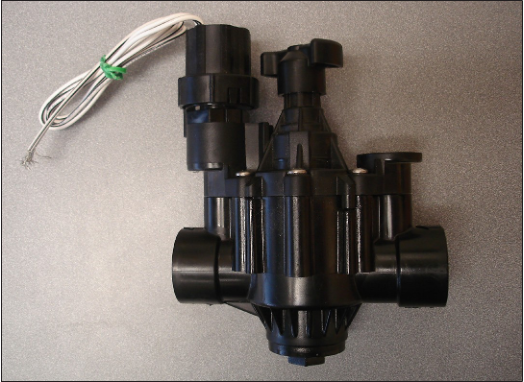 A black solenoid control valve.