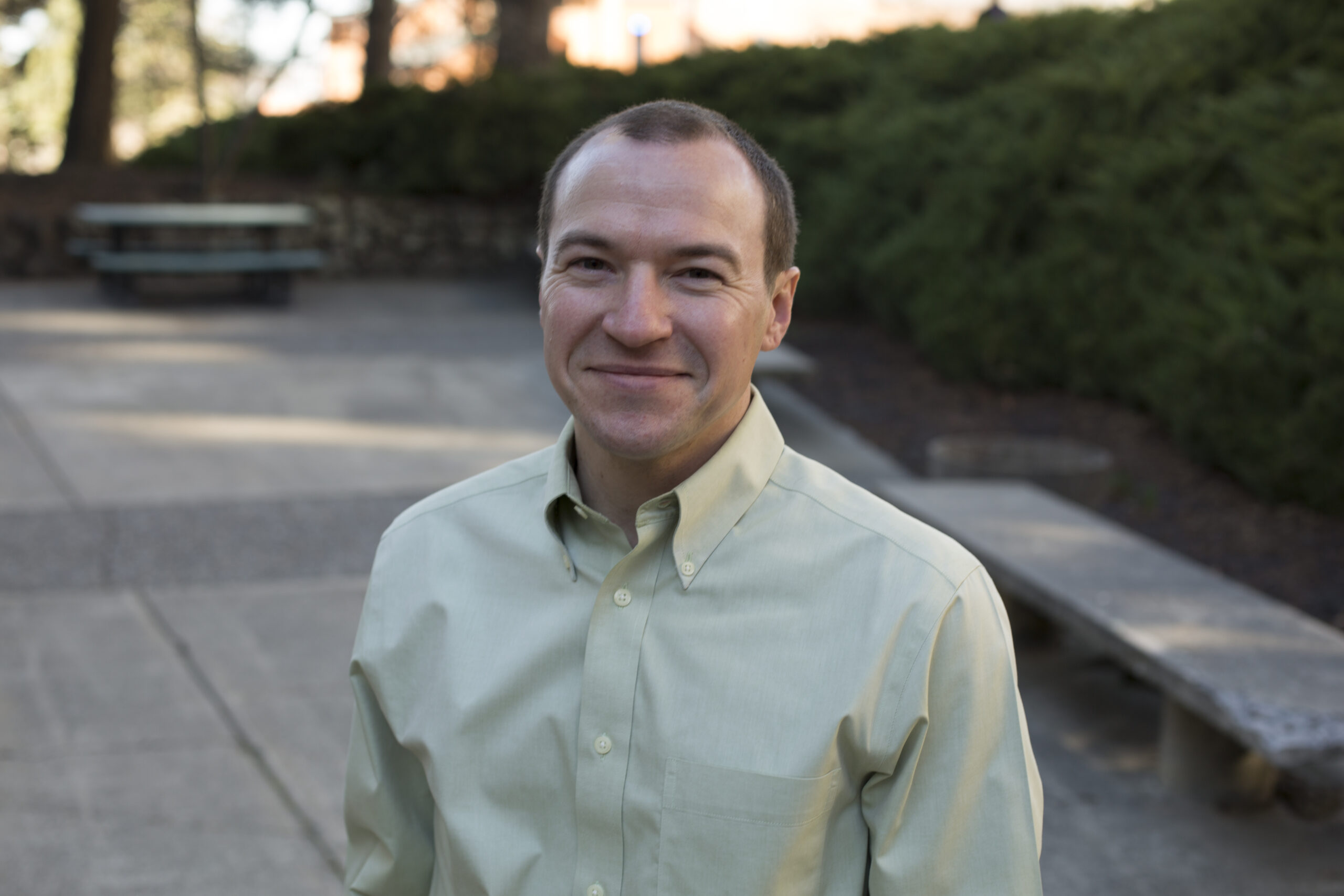 An image of Brian French standing outside, smiling and wearing a light green shirt.